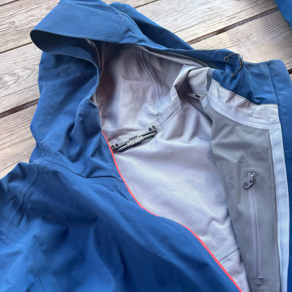 The Cham anorak unzipped and displaying the interior zip pocket.