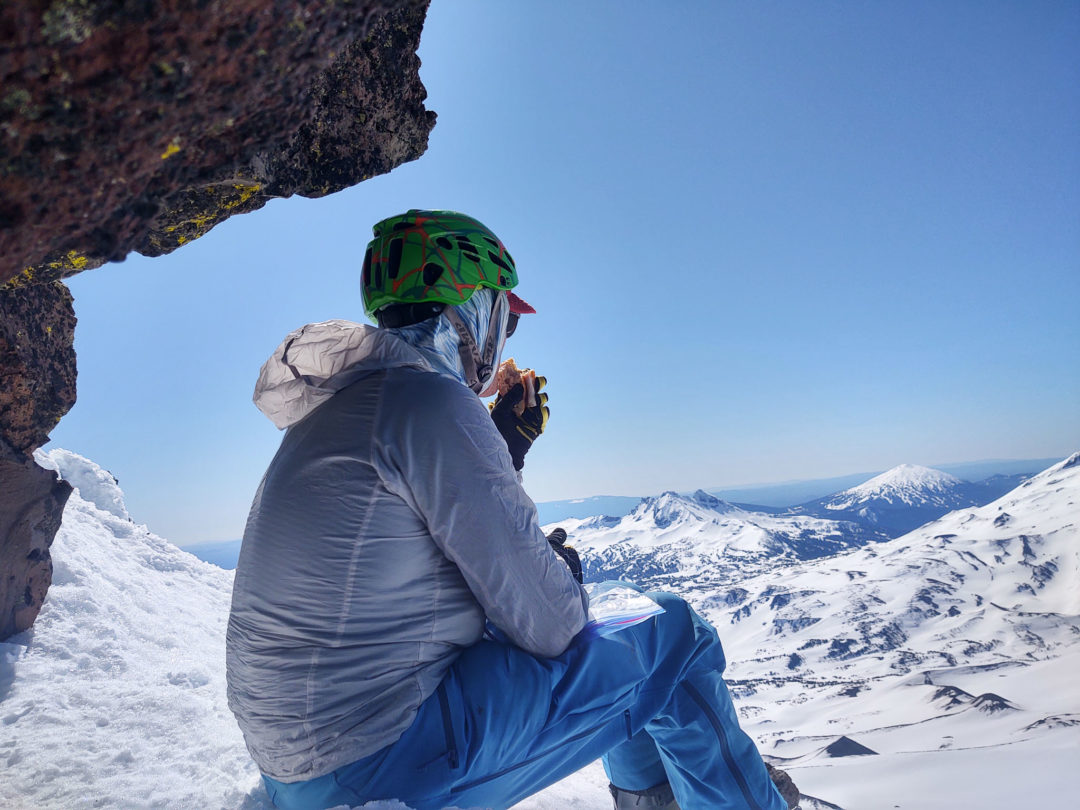 A Buff, softshell pants, a lightweight wind jacket (no Gore-Tex) , and enjoying lunch. 