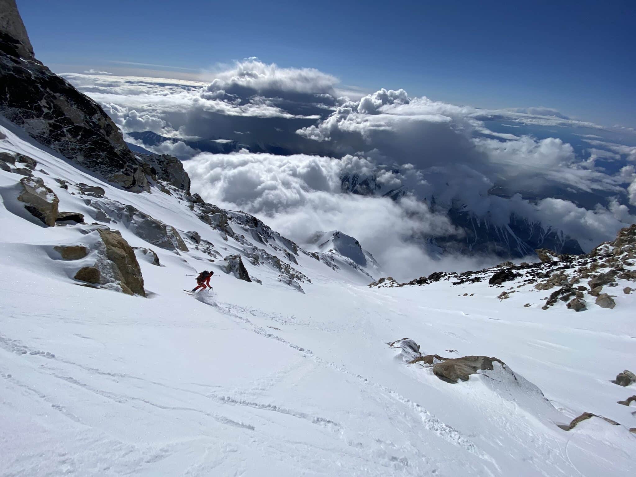 Up. And over. With skis on the back and the feet.