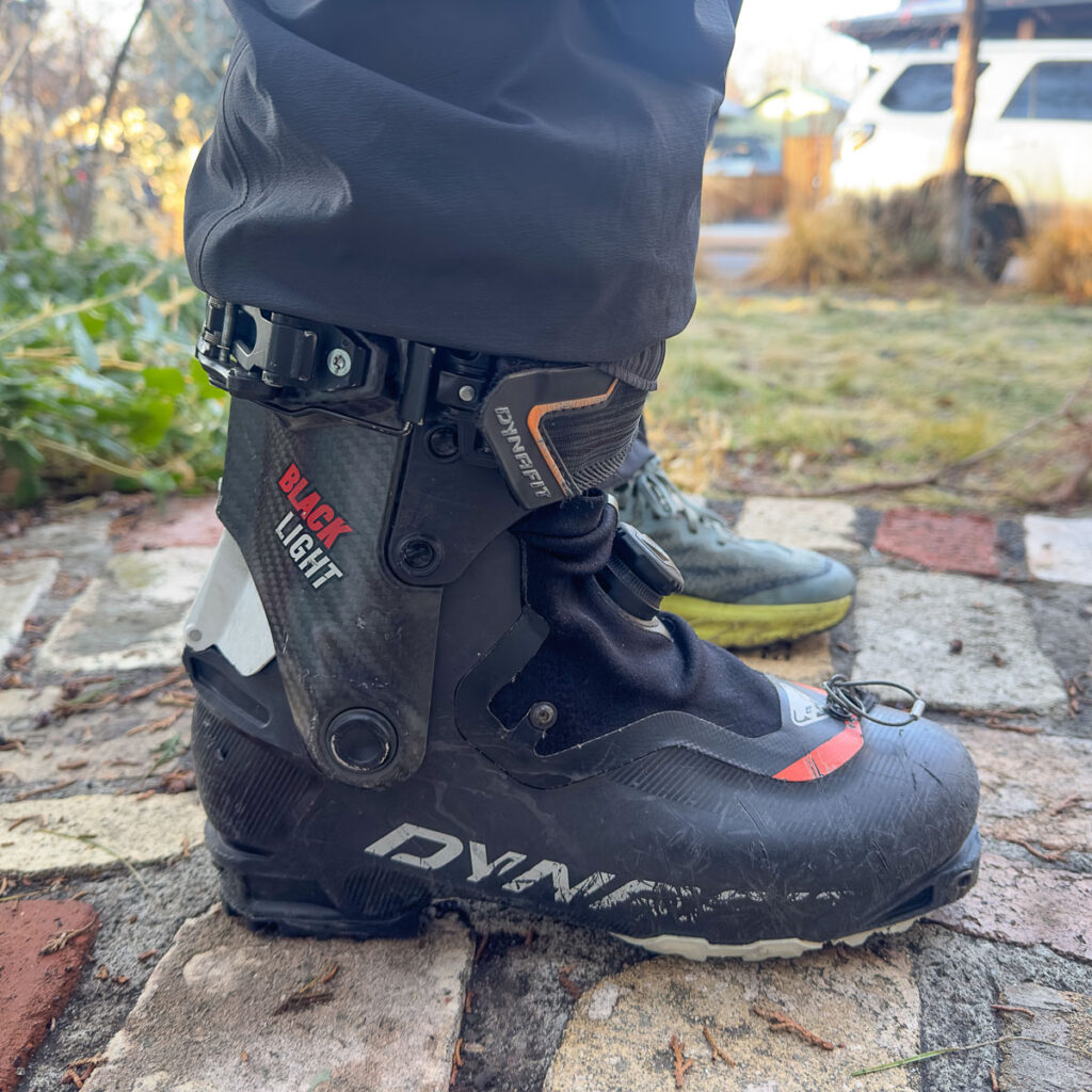 The simple elastic cuff pulls easily over a boot like the Dynafit Blacklight. These minimalist pants do not have scuff guards or gaiters.