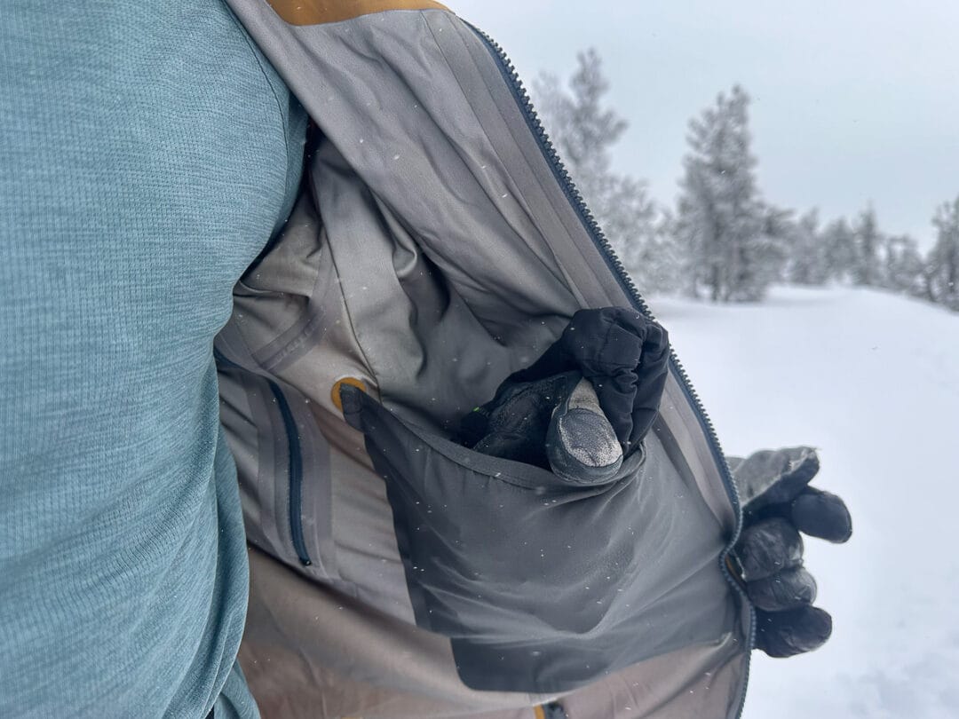 The single drop pocket can secure gloves, an extra hat, and other modestly bulky items. The Stormstride has a small vertically aligned zip pocket on the opposite side big enough for a phone, lip balm, and small essentials. 