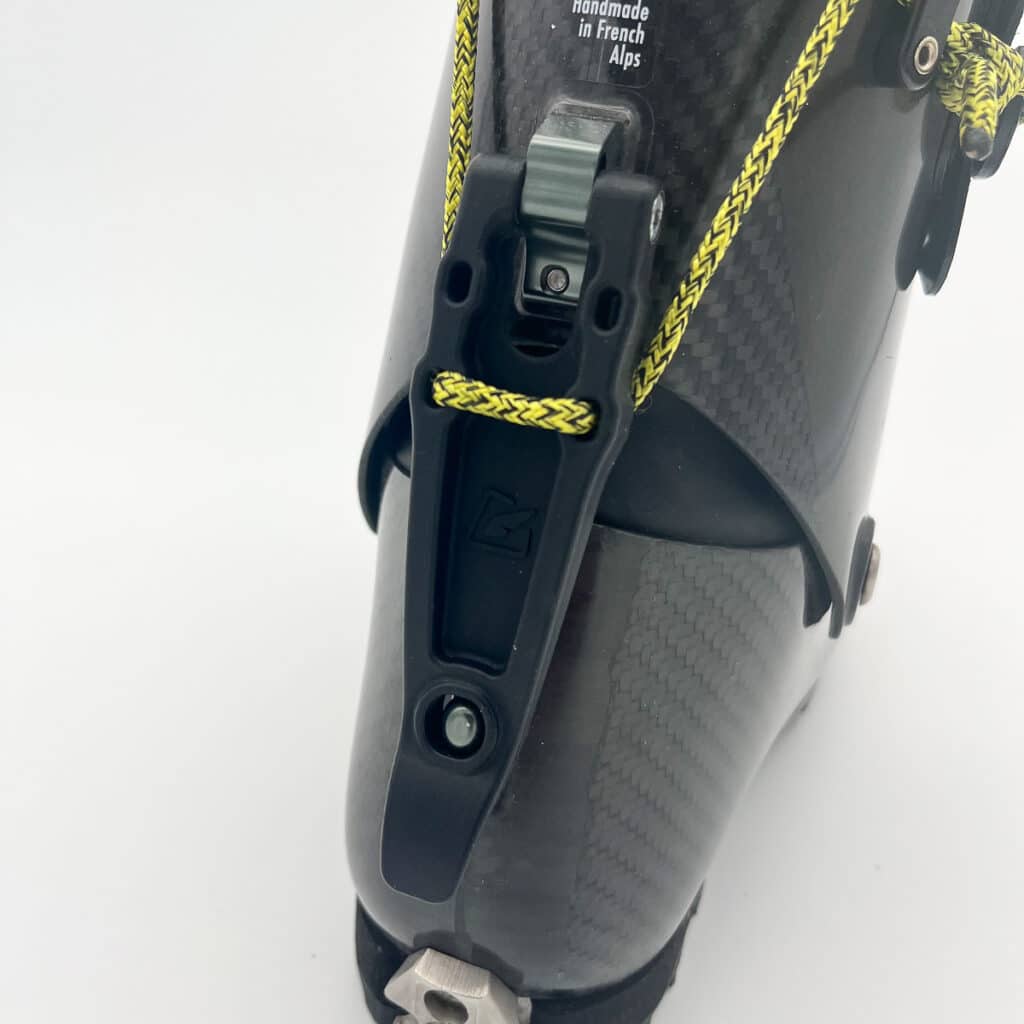 The walk/ski lever is plastic and actuates a string-style closure system, allowing for a single-motion transition. Uniquely, the strings attach to dual ratchet straps, providing greater surface area and security than the usual string and hook systems of race boots.