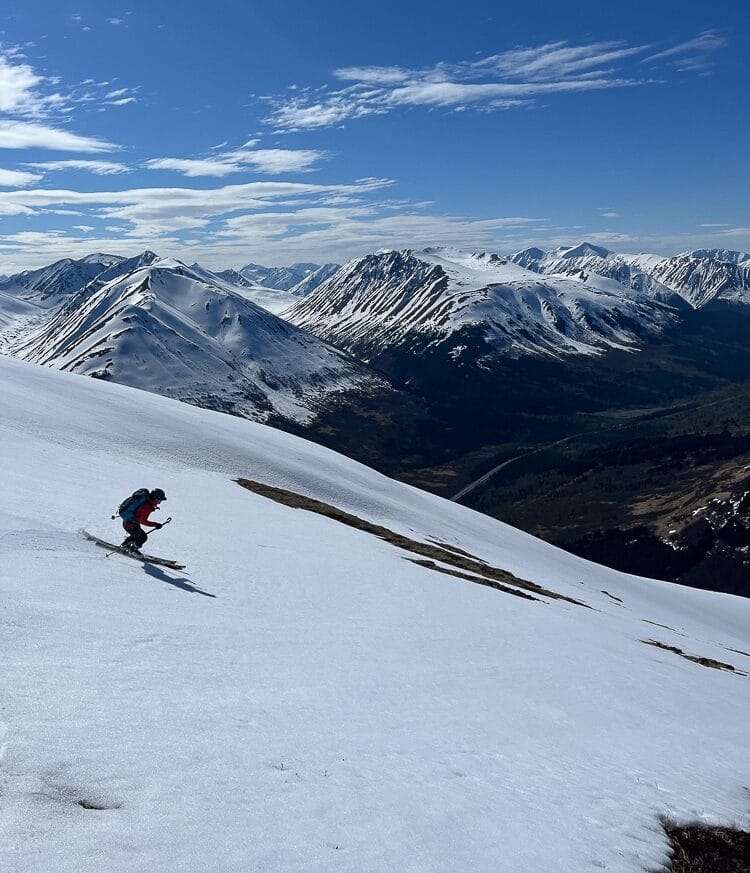 Carolyn Spencer sliding down summit's snow patches, Summit Lake, AK. Photo: Alex Palombo
