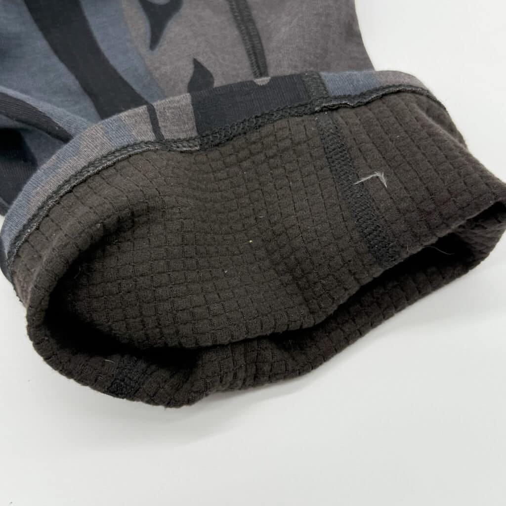 The cuff rolled up displays the next-to-skin gridded fabric.