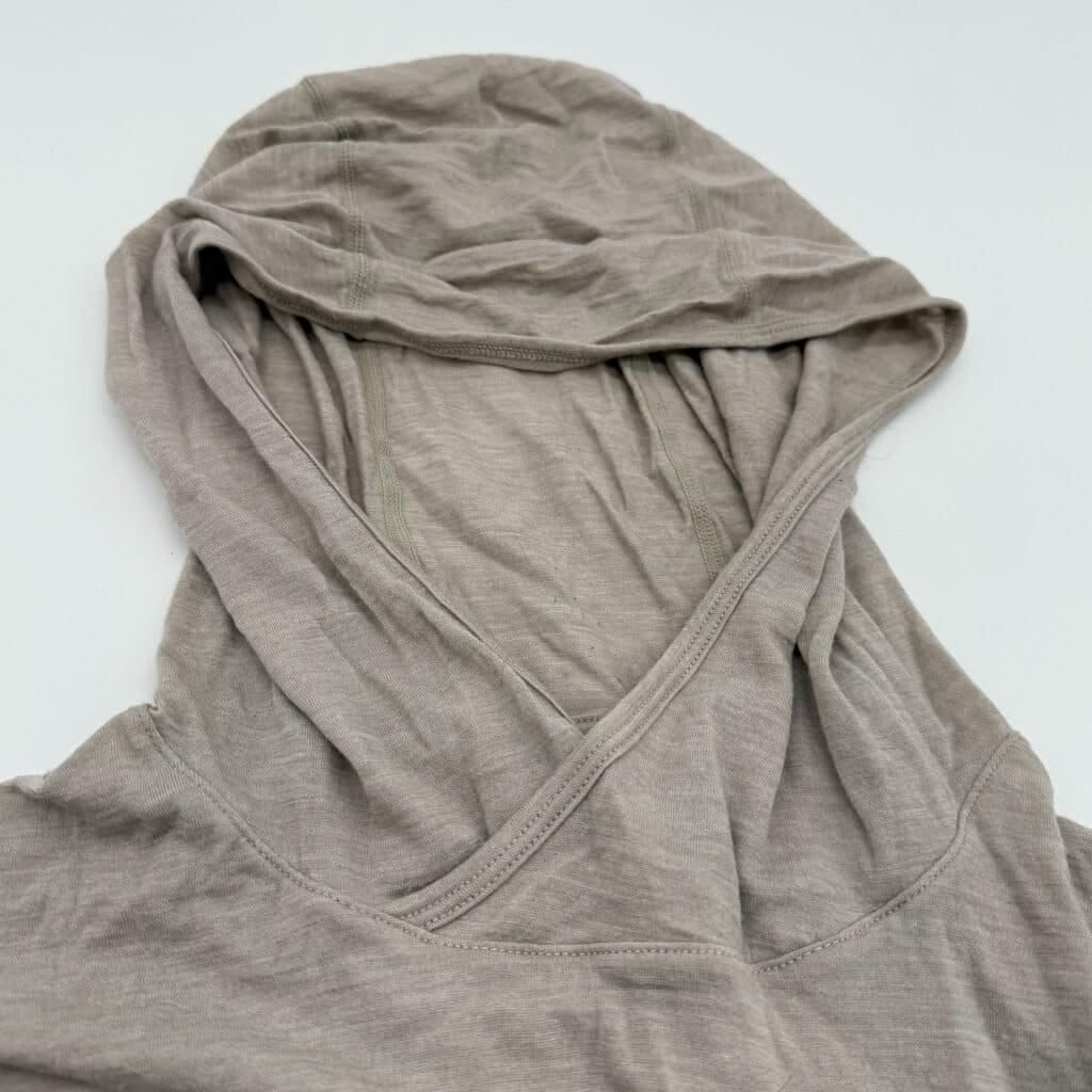 The generous hood and open neck design of the Featherweight Hooded Top.