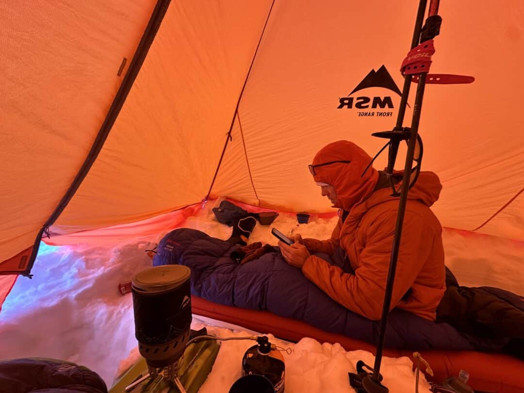 Using a remote canister WindBurner inside a mid. The canister and stove rest on a secure shovel blade. 