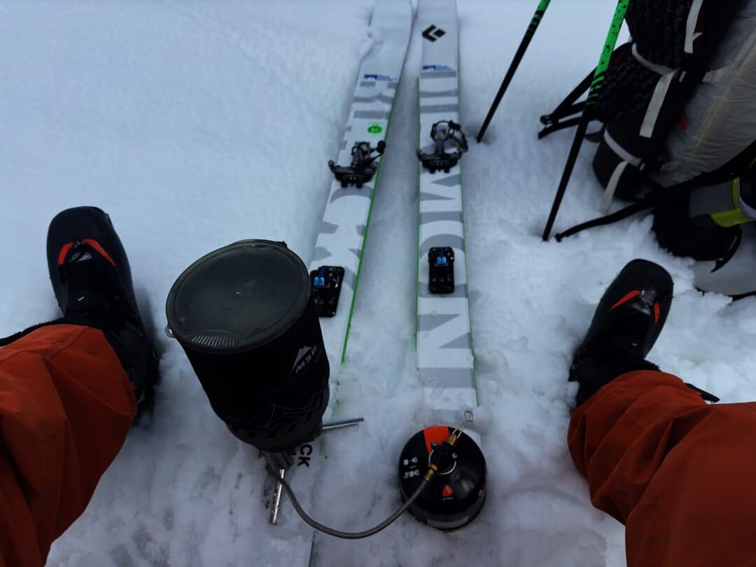 In a pinch, mid-tour, a remote canister stove gets put to use melting snow.