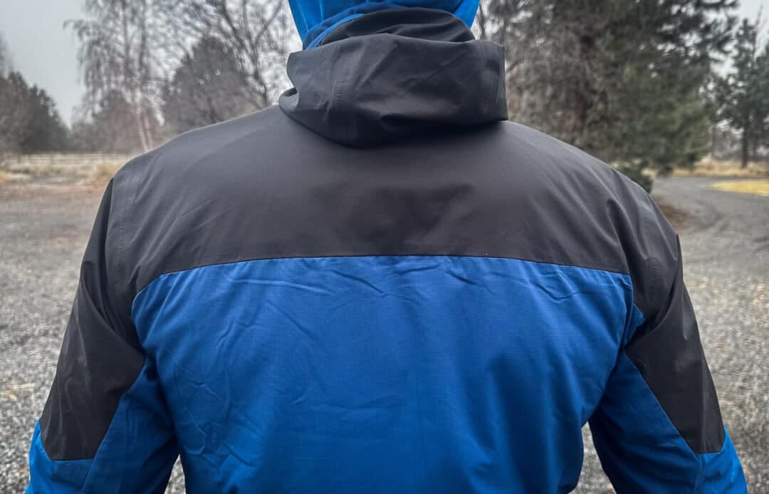 The yoke/upper arms are made from a more durable, weather-resistant fabric. The black fabric also indicates the jacket's uninsulated portions.
