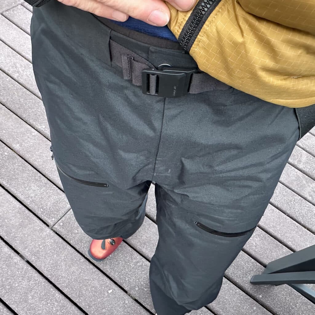 A button closure, a fly, and a minimalist waist best...+ some sweet removable suspenders (not shown). 