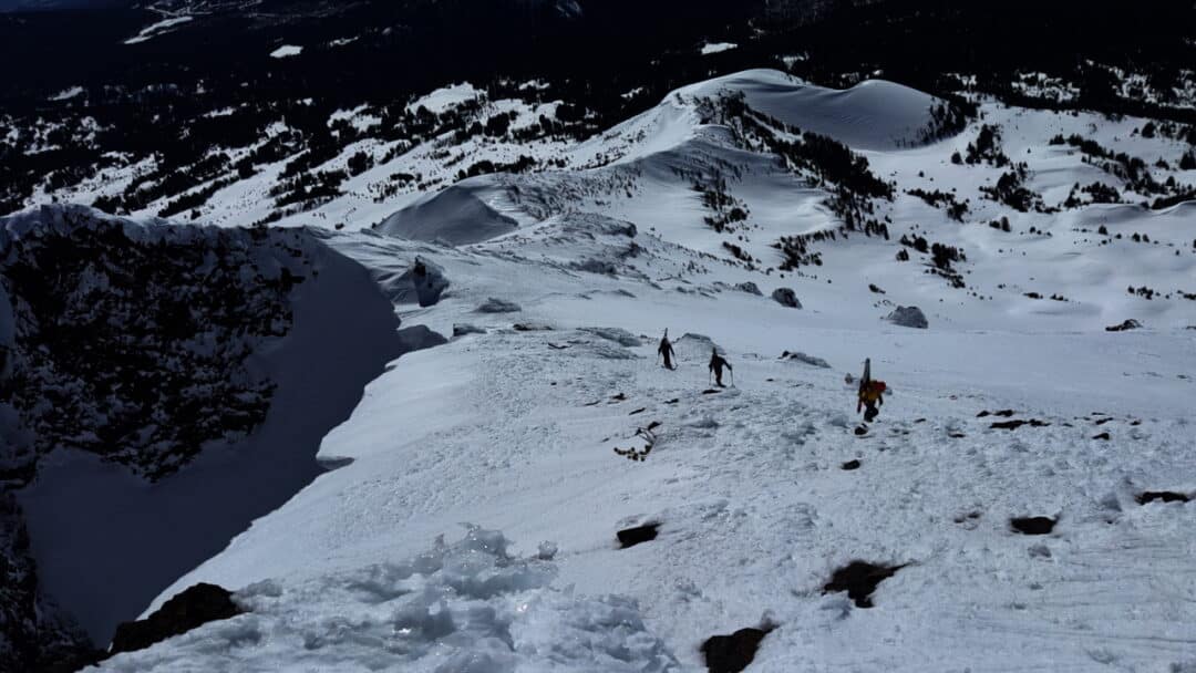 Hiking up on an interface of a south-facing and north/northeast-facing slope. The good soft snow turns will be found to the south.