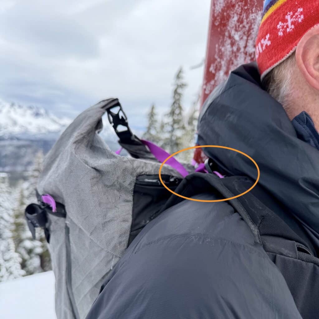 The skis are carried on the left side, with the skimo carry system clipped to the right shoulder strap. The pack fits/rides like a gem, but the clip point, when skis are secured, sits high on the shoulder strap. Not a big issue, but it takes a bit of a reach for me to unclip the system.
