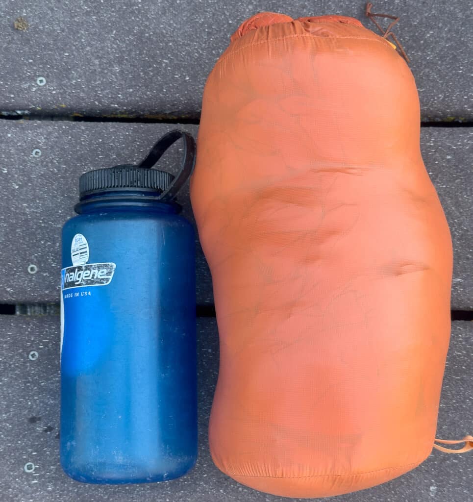 The Durable Down Parka is packed into a stuff sack to illustrate its compressed volume.