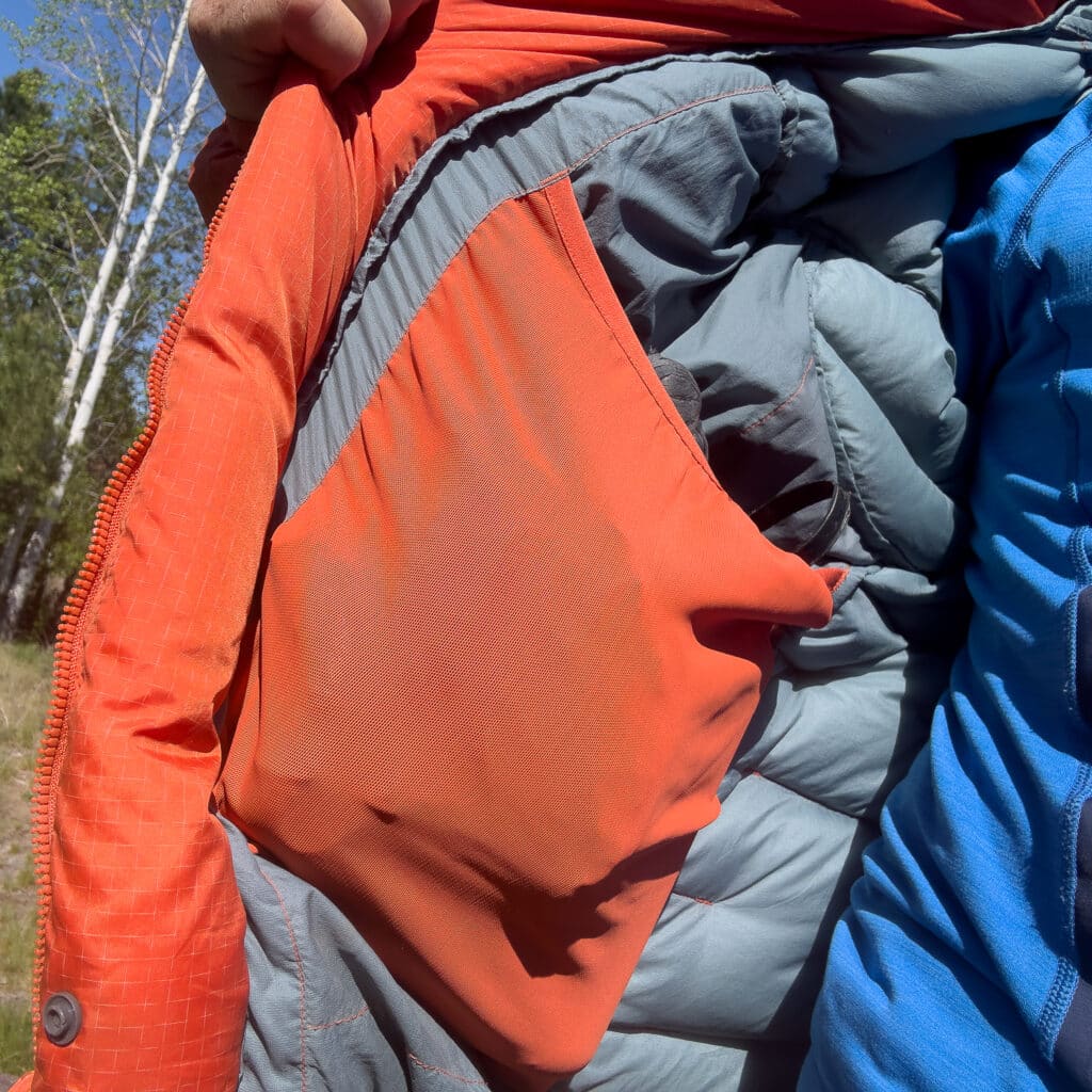 The Durable Down features two large drop-in pockets. Shown here, the pocket is filled with a liter Nalgene and a pair of mid-weight gloves.