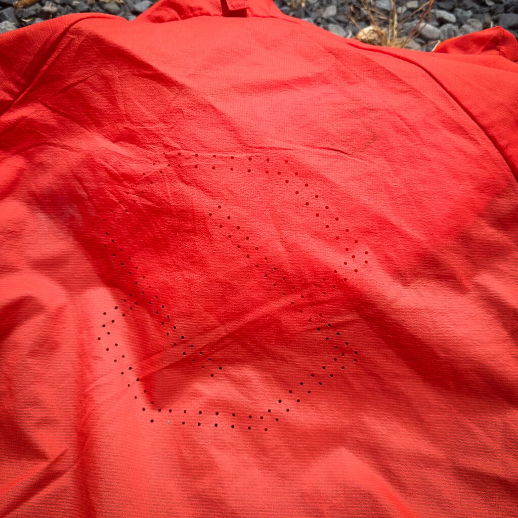 The back/shoulder zone has perforations to help dump heat.